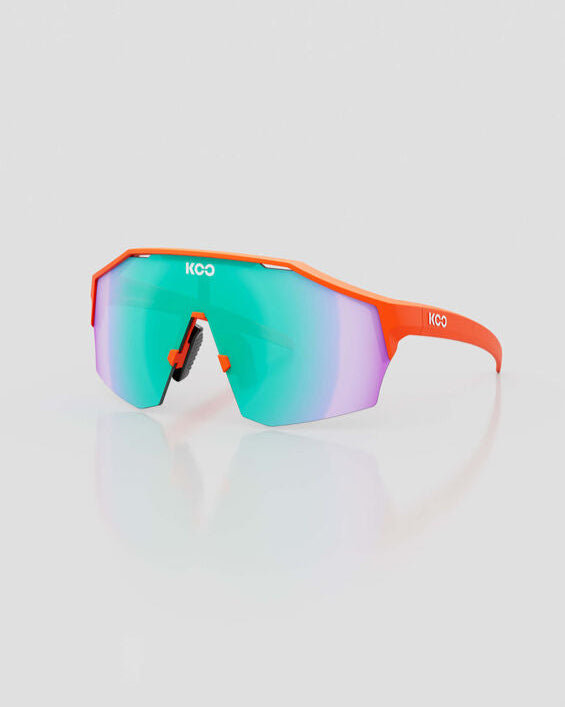 Sunglasses with orange frame and multicolored lenses on a light gray background