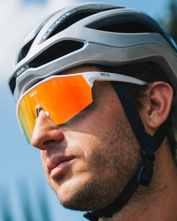 Person wearing a helmet and sunglasses with a blurred background