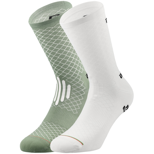 Two socks, one green with geometric pattern and one white, on a white background.