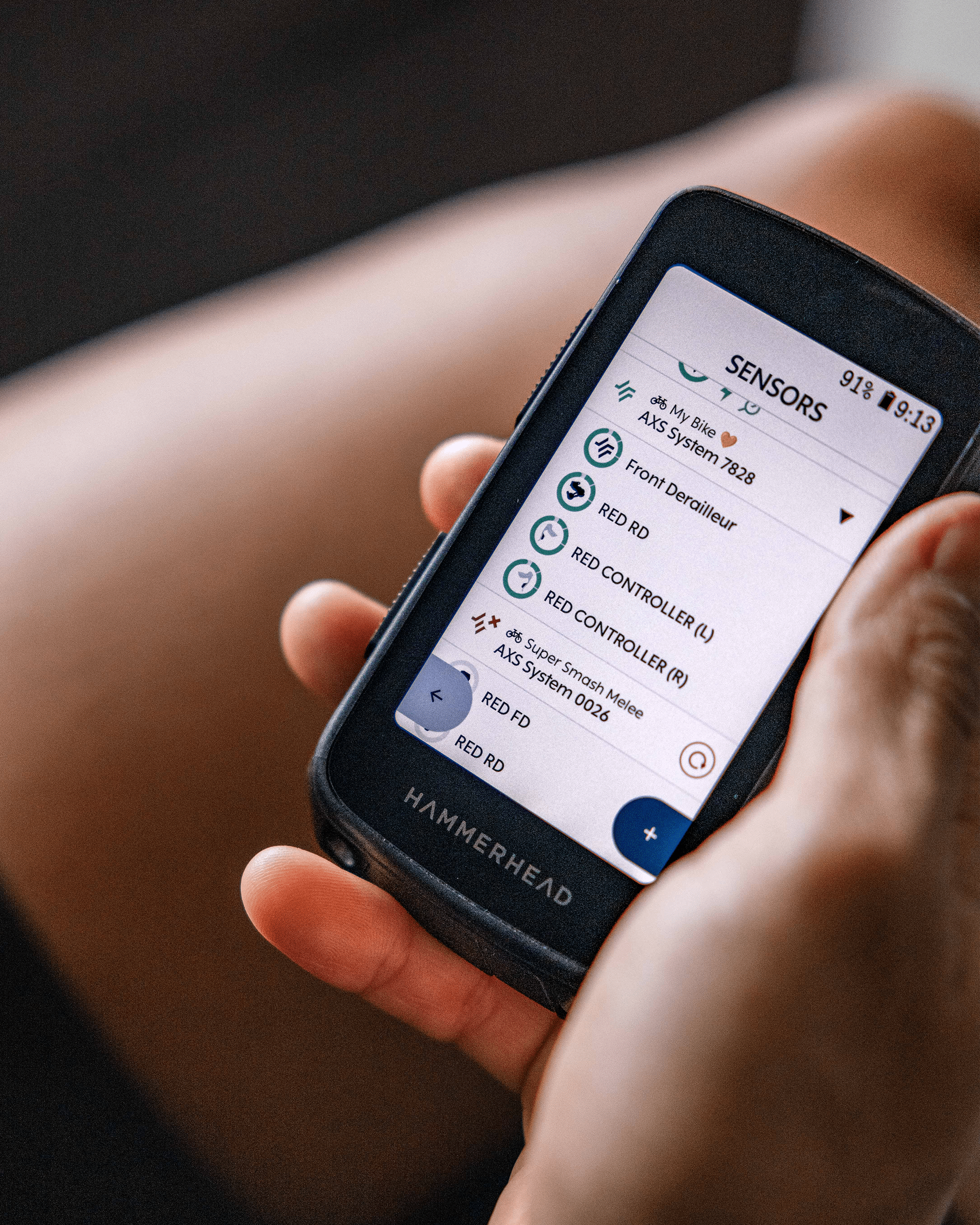 Person holding a smartphone with a 'HAMMERHEAD' device app open, showing sensor data.