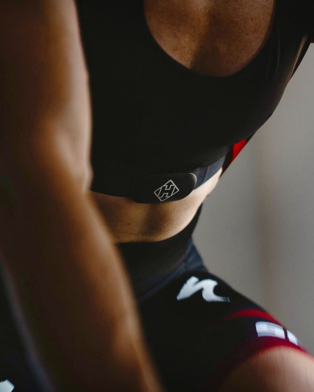 Person wearing a black athletic outfit with visible branding.